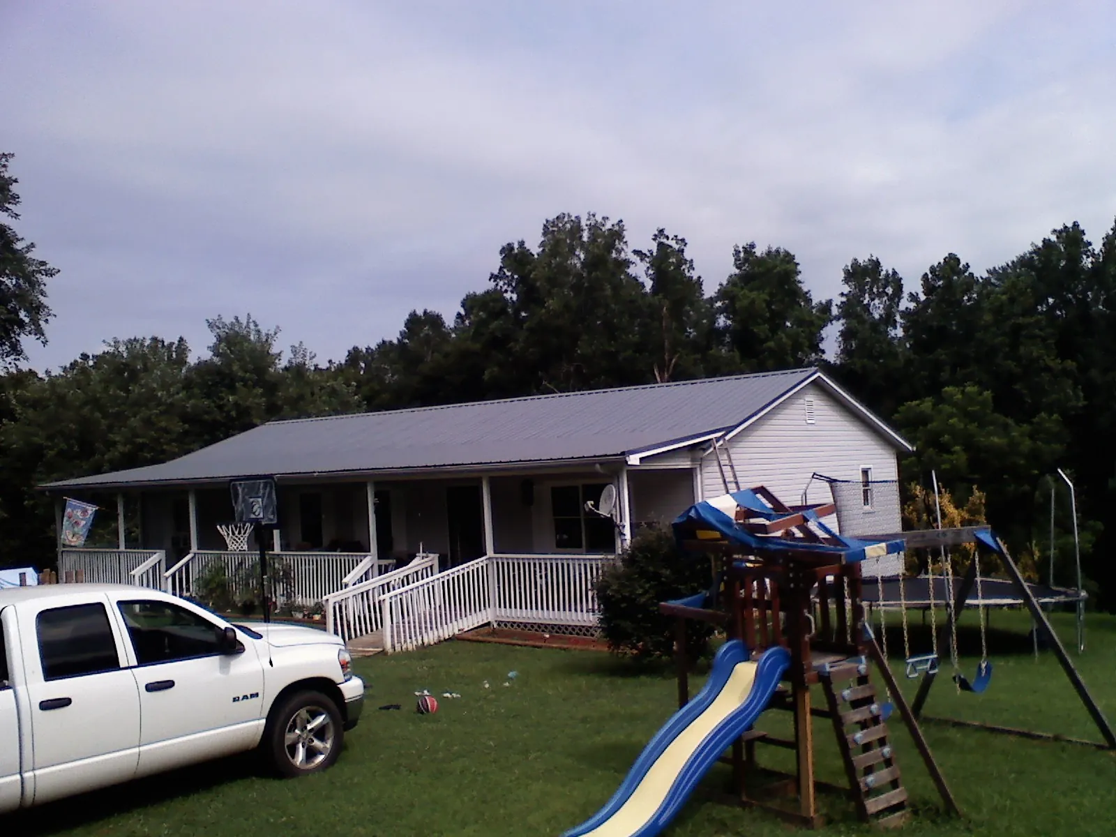 Dark metal roof on a country home with a full length front porch in Spring Green